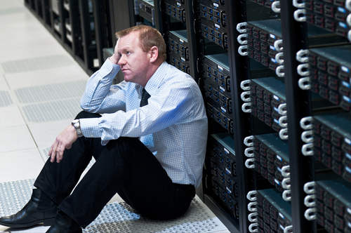 data center recycling, laptop recycling, server recycling, image showing a worried man sitting on the floor
